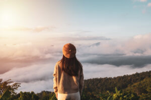 A woman looking out- gratitude, new memories, healing and hiking after chronic illness. healing emotional hurdles