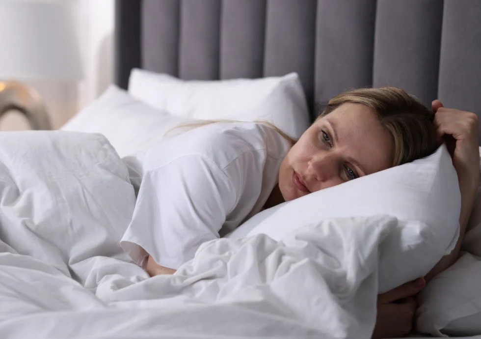 Woman with hot flash in bed